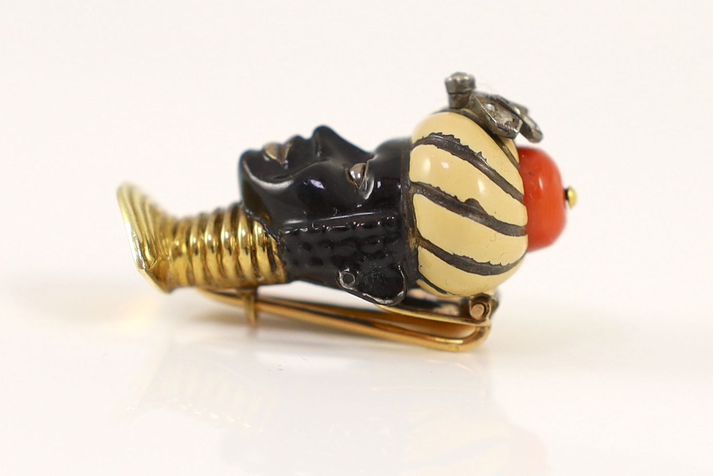 An early to mid 20th century French Cartier 18ct gold, enamel, coral and rose cut diamond set clip brooch, modelled as the bust of a Blackamoor